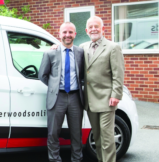 An image of Kevin and Mike Sherwodd standing in front of a Sherwoods van